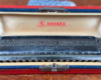 This lot features a vintage Hohner 64 Chromonica 16-hole chromatic harmonica, made in Germany. 