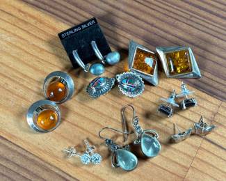 This lot features a curated collection of eight (8) pairs of sterling silver earrings with a total approx. weight of 32.21 grams.