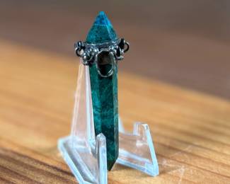 This lot features an antique pendant featuring Malachite wrapped in sterling silver. This pendant measures, 2.5” H.