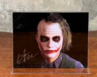 This lot features a signed photograph of actor Heath Ledger, obtained in person on film location of Dark Knight in Chicago, Illinois.