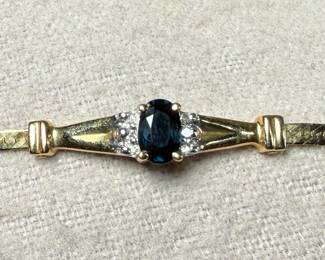 This lot features a stunning 14k gold bracelet with genuine diamonds and what appears to be a sapphire center stone. The bracelet measures, 7” and has a total approx. weight of 3.26 grams.