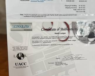 This lot features a signed photograph by actor Heath Ledger and comes with a certificate of authenticity.