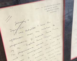 This lot features a professionally framed two-sided letter signed by composer, Ralph Vaughan Williams along with a LP by composer Sir John Barbirolli. Measures in frame, 31” H x 21.5” W.