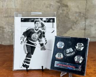 This lot features a vintage photograph of Wayne Gretzky held in a protective sleeve, along with a limited edition commemorative pin set.