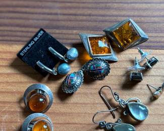 This lot features a curated collection of eight (8) pairs of sterling silver earrings with a total approx. weight of 32.21 grams.