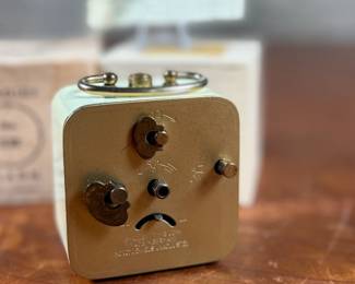 This lot features a vintage Bradley mechanical travel alarm clock, manufactured in Germany and is in good working condition.