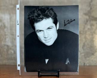 This lot features a signed photograph of actor Eric Close.