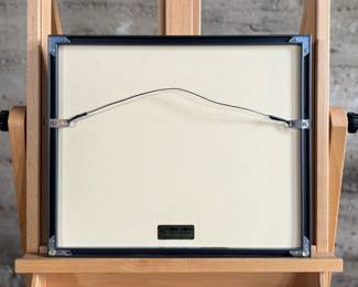 This lot features a professionally framed program signed by composer, Aaron Copland. Measures in frame, 15” H x 17.5” W.