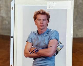 This lot features a signed photograph of actor Val Kilmer and comes with a certificate of authenticity.