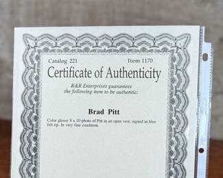 This lot features a signed photograph of actor Brad Pitt and comes with a certificate of authenticity.