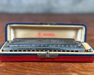 This lot features a vintage Hohner 64 Chromonica 16-hole chromatic harmonica, made in Germany. 