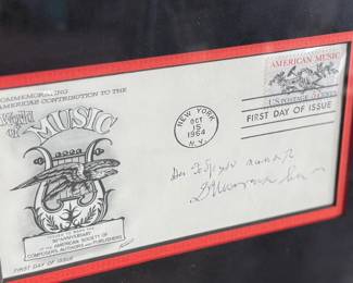 This lot features a professionally framed signed cachet by Russian Composer, Dmitry Shostakovich. Accompanied with a certificate of authenticity. Measures in frame, 25.5” H x 19.75” W.