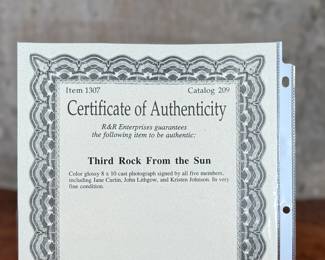 This lot features a signed photograph by the cast of Third Rock From the Sun including actors Jane Curtin, John Lithgow, Kristen Johnson, and more.