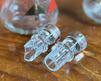 This lot features a rare mid-century Gay Fad "Moon" pattern set circa 1950s featuring atomic-style red and gold triangles and dots. The set includes a clear glass serving bowl, matching wooden serving utensils, and two glass cruets with stoppers. One of the stoppers has damage as shown in photos.