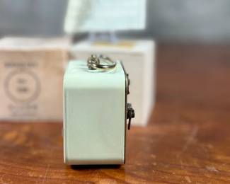 This lot features a vintage Bradley mechanical travel alarm clock, manufactured in Germany and is in good working condition.