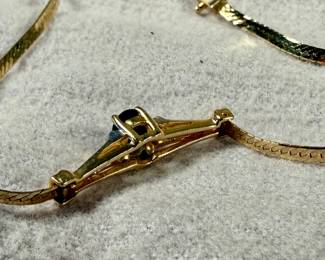 This lot features a stunning 14k gold bracelet with genuine diamonds and what appears to be a sapphire center stone. The bracelet measures, 7” and has a total approx. weight of 3.26 grams.