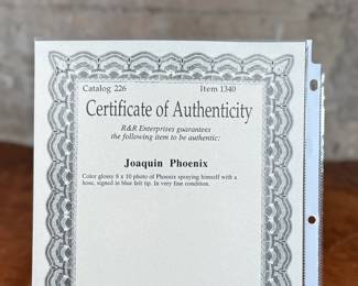 This lot features a signed photograph of actor Joaquin Phoenix and comes with a certificate of authenticity.