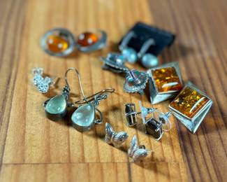 This lot features a curated collection of eight (8) pairs of sterling silver earrings with a total approx. weight of 32.21 grams.