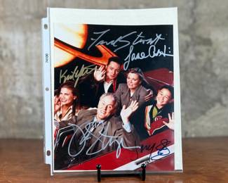 This lot features a signed photograph by the cast of Third Rock From the Sun including actors Jane Curtin, John Lithgow, Kristen Johnson, and more.