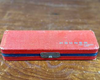 This lot features a vintage Hohner 64 Chromonica 16-hole chromatic harmonica, made in Germany. 