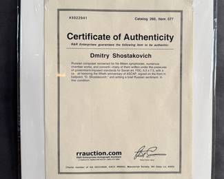 This lot features a professionally framed signed cachet by Russian Composer, Dmitry Shostakovich. Accompanied with a certificate of authenticity. Measures in frame, 25.5” H x 19.75” W.