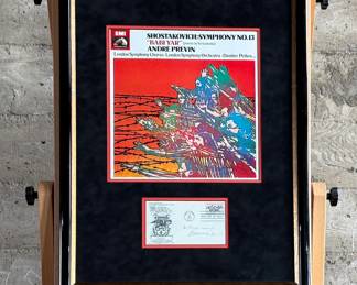 This lot features a professionally framed signed cachet by Russian Composer, Dmitry Shostakovich. Accompanied with a certificate of authenticity. Measures in frame, 25.5” H x 19.75” W.