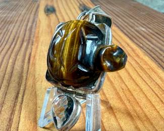This lot features a vintage pendant with a carved piece of Tiger’s Eye in the shape of a turtle, wrapped in sterling silver. This pendant measures, 2.5” H and has a total approx. weight of 21.97 grams.