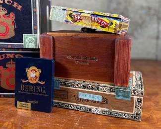 This lot features a curated collection of vintage cigar boxes in various conditions.