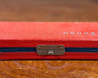 This lot features a vintage Hohner 64 Chromonica 16-hole chromatic harmonica, made in Germany. 