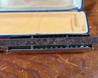 This lot features a vintage Hohner 64 Chromonica 16-hole chromatic harmonica, made in Germany. 