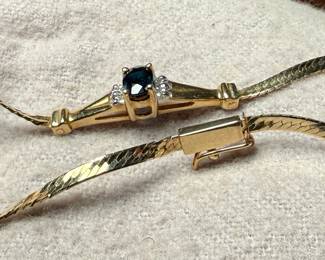 This lot features a stunning 14k gold bracelet with genuine diamonds and what appears to be a sapphire center stone. The bracelet measures, 7” and has a total approx. weight of 3.26 grams.