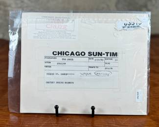 This lot features a vintage photograph of Wayne Gretzky held in a protective sleeve, along with a limited edition commemorative pin set.