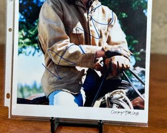 This lot features a signed photograph by actor Heath Ledger and comes with a certificate of authenticity.