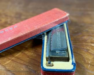 This lot features a vintage Hohner 64 Chromonica 16-hole chromatic harmonica, made in Germany. 