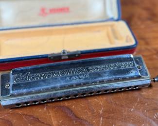 This lot features a vintage Hohner 64 Chromonica 16-hole chromatic harmonica, made in Germany. 