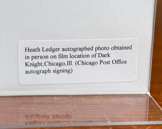 This lot features a signed photograph of actor Heath Ledger, obtained in person on film location of Dark Knight in Chicago, Illinois.