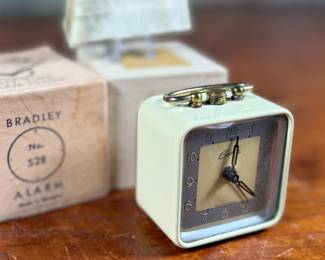 This lot features a vintage Bradley mechanical travel alarm clock, manufactured in Germany and is in good working condition.