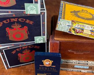 This lot features a curated collection of vintage cigar boxes in various conditions.