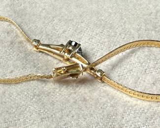 This lot features a stunning 14k gold bracelet with genuine diamonds and what appears to be a sapphire center stone. The bracelet measures, 7” and has a total approx. weight of 3.26 grams.