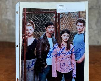 This lot features a signed photograph by the cast of Roswell including actors Shiri Appleby, Jason Behr, and more.