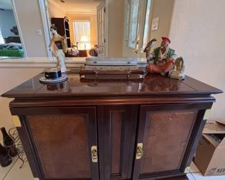 Asian-style foldable liquor cabinet or serve bar featuring dark wood construction and decorative brass pulls. 