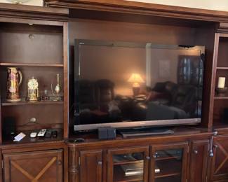 Large darkwood entertainment center. CAN BE SEPARATED INTO 3 PIECES