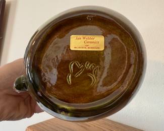 main floor bedroom with bed in it. down hallway to the right.