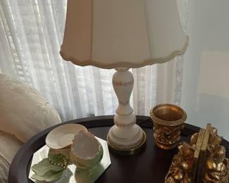 vintage white and gold ceramic table lamp, similar to styles produced in the 1950s or 1960s. 
