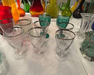 Fostoria crystal iced tea glasses in the "Wedding Ring" pattern with a platinum rim, produced between 1953 and 1975. 
Dimensions: Approximately 6 1/8 inches high with a 3 1/2 inch diameter. 
