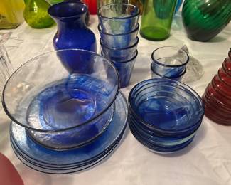 collection features vintage Bormioli Rocco Murano cobalt blue glass tableware, including serving bowls, plates, and tumblers with a distinctive blue-and-clear swirl pattern. 
