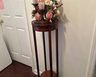antique Edwardian mahogany plant stand. with multi-tiered wooden candelabra styled with artificial flowers and votive candles. 