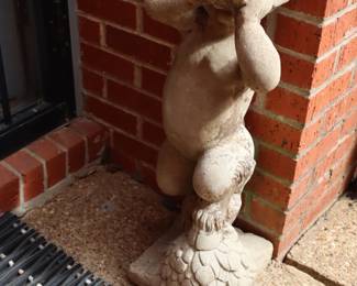 Mythological figure, mischievous cherub-like casted in cement, front door                                                                                                                                                                                                                                                                                                                                                                                 