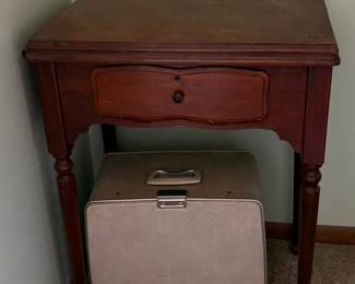 Antique Singer sewing machine in cabinet; Portable sewing machine
