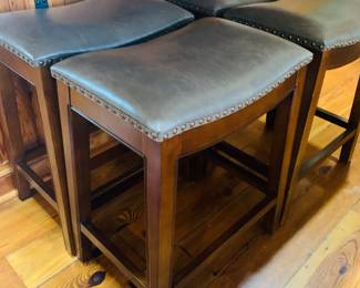 four counter height leather topped bar stools